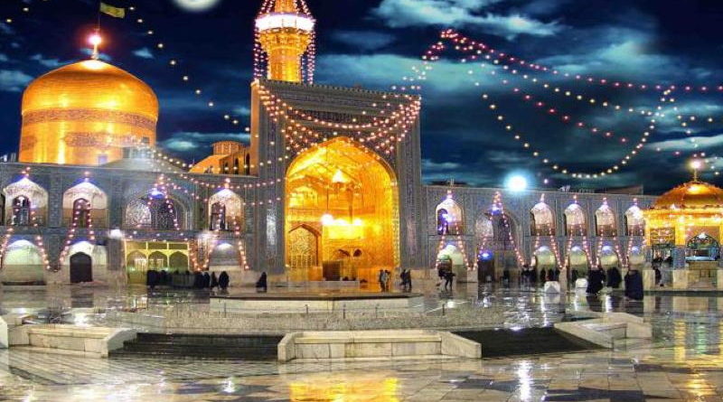 Illuminated mosque courtyard at night under a moonlit sky.