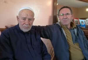 The illuminated facade of Al-Ajami Restaurant at night.