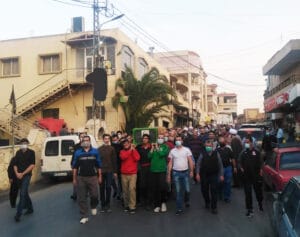 The illuminated facade of Al-Ajami Restaurant at night.
