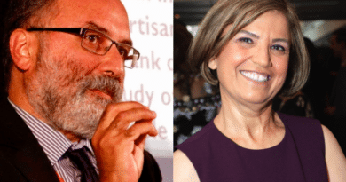 A man speaking passionately and a woman smiling at a formal event.