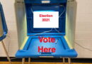 A voting booth with a sign saying 'Election 2021' and 'Vote Here'.