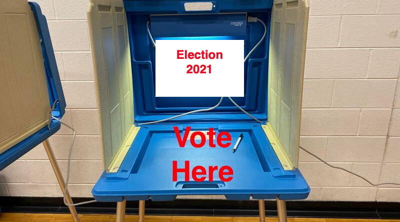 A voting booth with a sign saying 'Election 2021' and 'Vote Here'.