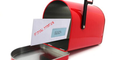 Red mailbox with an open door and a letter inside.