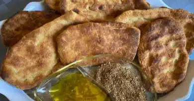 Freshly baked flatbreads served with olive oil and za'atar spice.