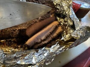 The illuminated facade of Al-Ajami Restaurant at night.