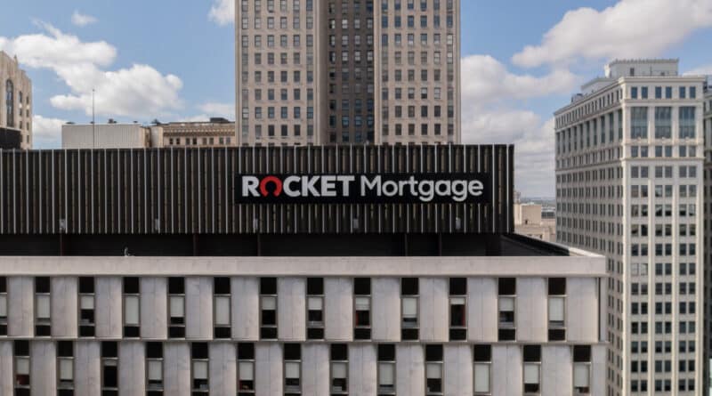 Rocket Mortgage sign on a building under a partly cloudy sky.