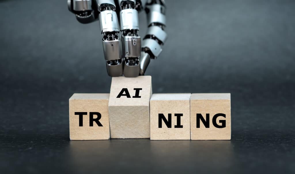 Robot assembling blocks to form 'AI TRAINING'.