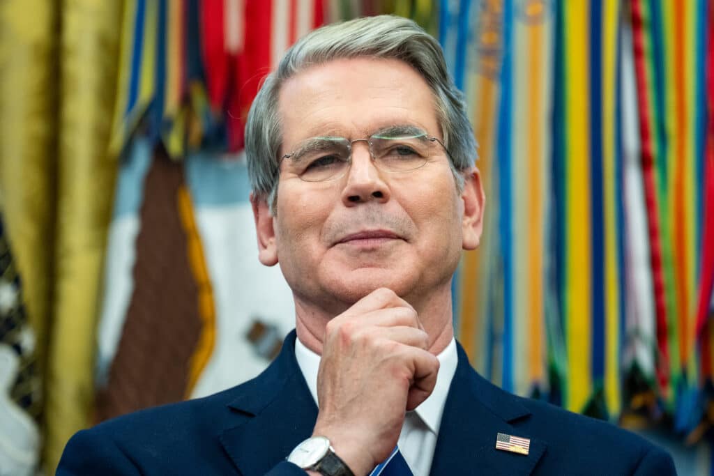 A distinguished man in a suit with a thoughtful expression.